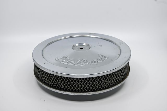 Chrome Edelbrock air cleaner with surface wear on the lid