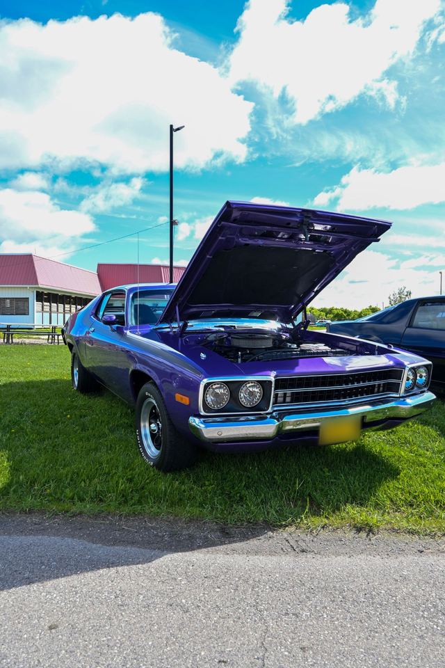 Purple classic Plymouth, front three-quarter view with the hood open