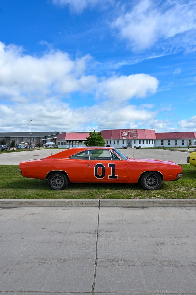 Orange Dodge Charger '01' replica in side profile under a blue sky